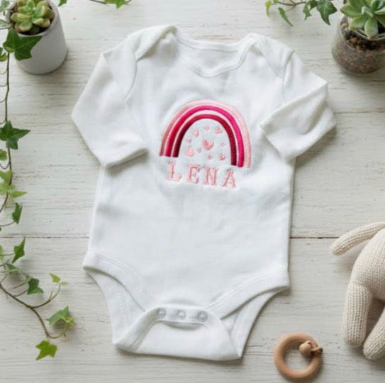 Custom rainbow hearts embroidered baby grow by Rebel Needleworks - personalised baby gift UK