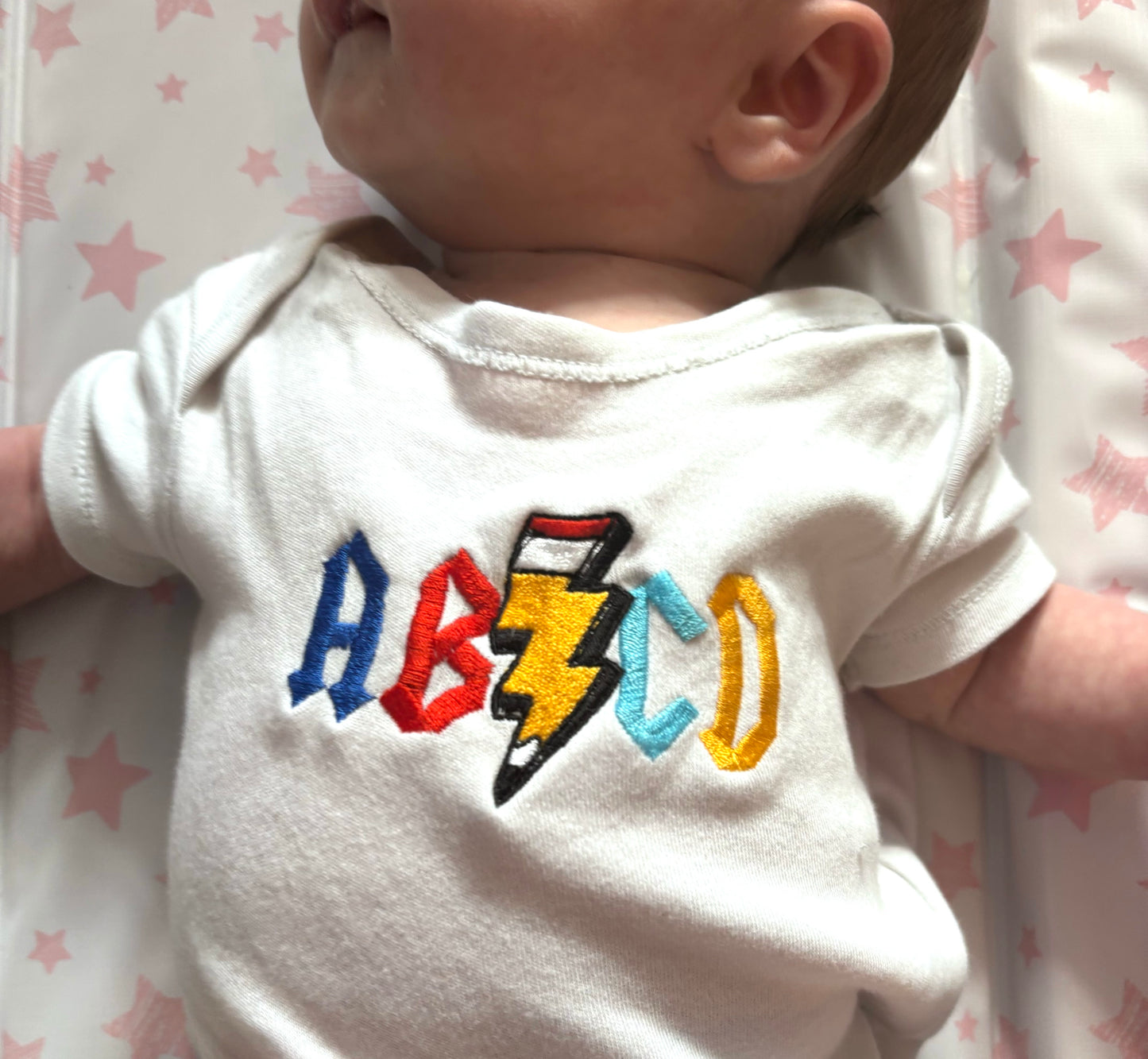 Rebel Needleworks ABCD embroidered baby grow - custom alphabet newborn gift UK