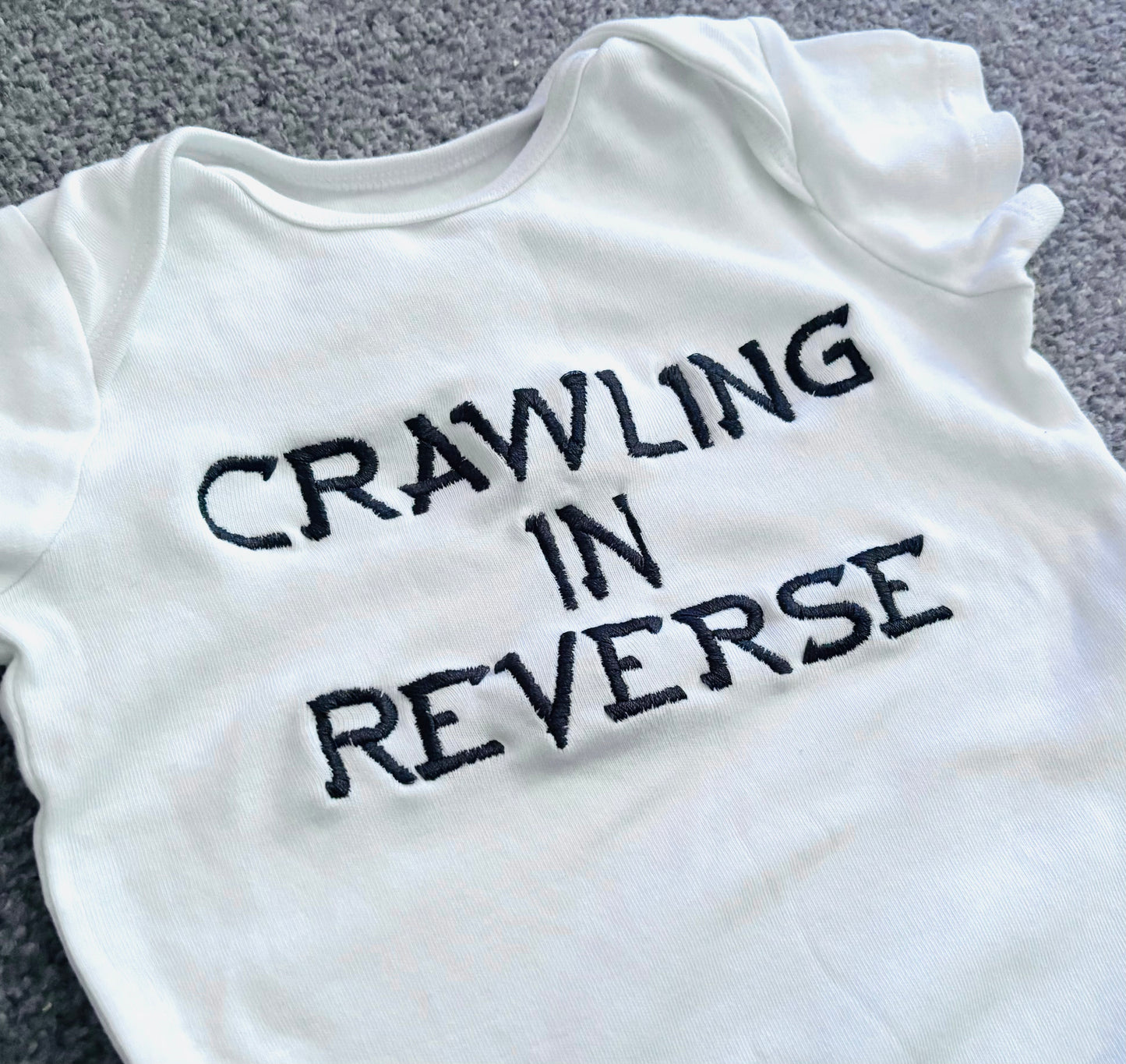 Crawling In Reverse Embroidered Baby Grow