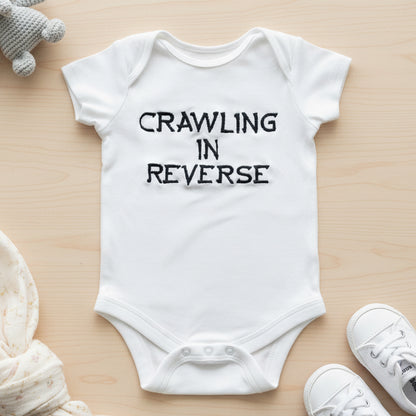 Custom crawling in reverse embroidered baby grow by Rebel Needleworks - funny baby gift UK