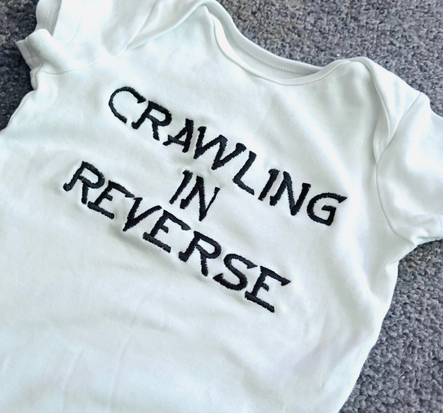 Crawling In Reverse Embroidered Baby Grow