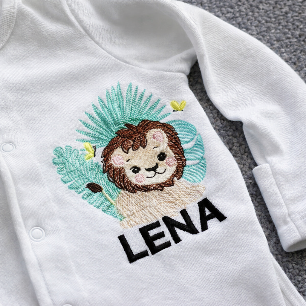 Custom safari lion embroidered sleepsuit by Rebel Needleworks - personalised baby gift UK