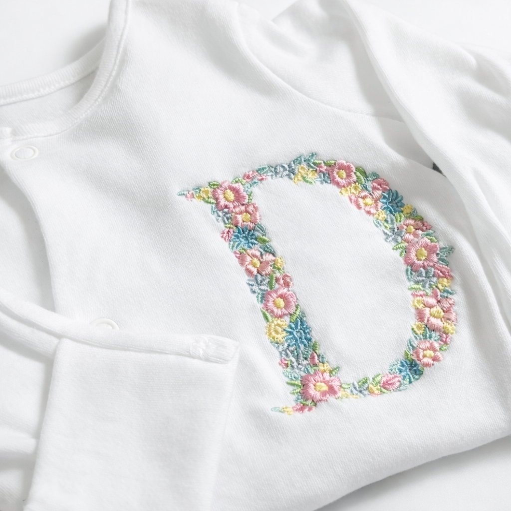 Floral letter embroidered sleepsuit by Rebel Needleworks - personalised baby girl gift UK