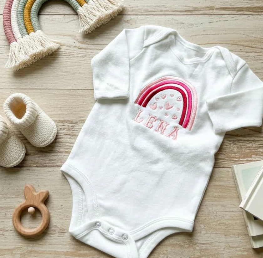 Rainbow with hearts personalised embroidered baby grow by Rebel Needleworks - custom newborn gift UK