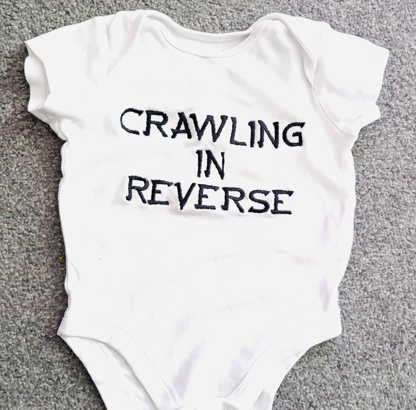 Crawling In Reverse Embroidered Baby Grow