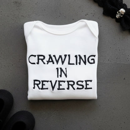 Crawling in reverse embroidered baby grow by Rebel Needleworks - funny personalised baby gift UK