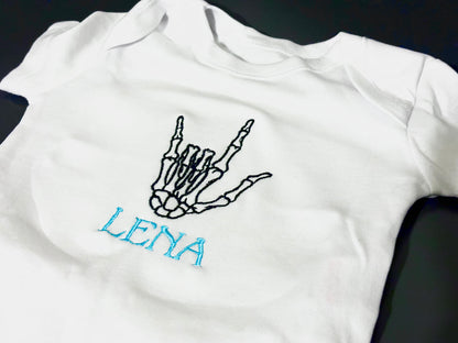 Custom skeleton rock hands embroidered sleepsuit by Rebel Needleworks - gothic alternative baby gift UK