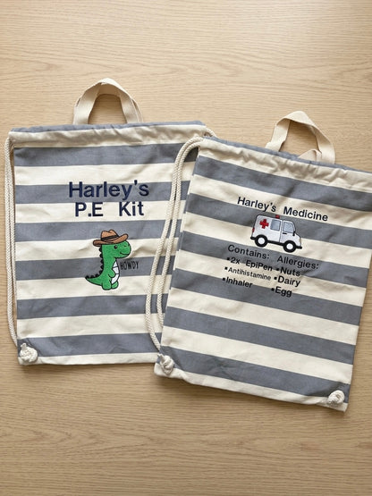 Two striped fabric drawstring bags laid flat on a light wood surface. Embroidered medical I formation and PE kit bags.